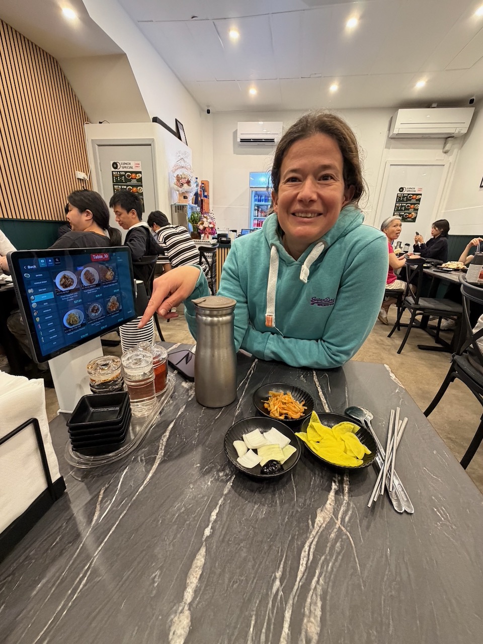 Steph sitting at a Korean restaurant in Lidcombe on the first evening of the trip.