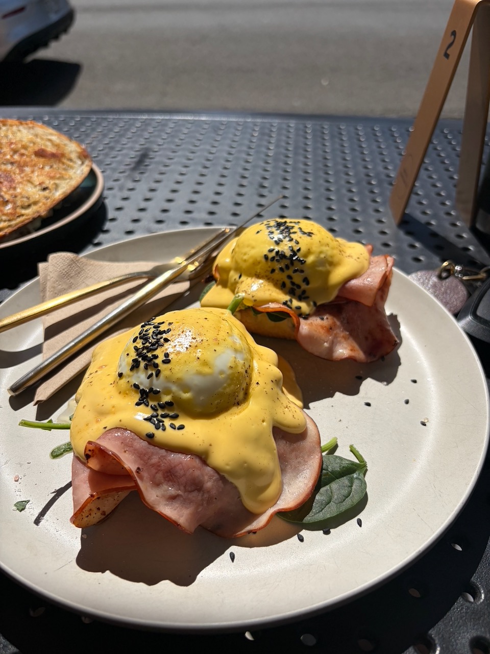 Eggs benedict with hollandaise sauce and sesame seeds at a Wollongong cafe.