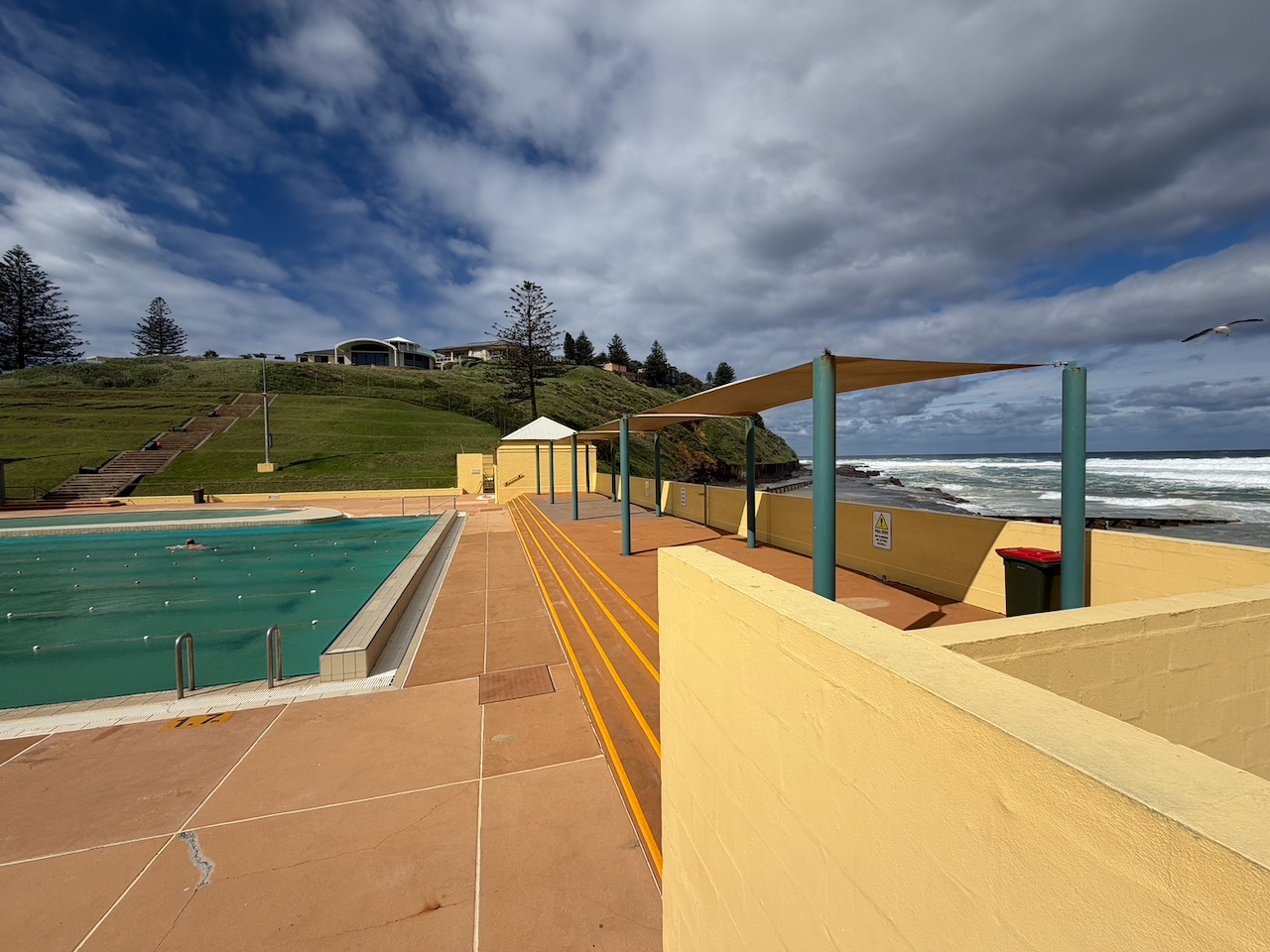 Port Kembla Pool beside the ocean under a dramatic sky.