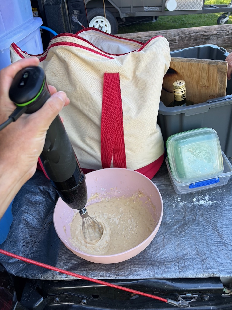Mixing corn tortilla batter with a hand blender at the camp table.